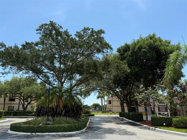a view of a tree in front of a house
