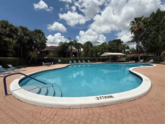 a view of a swimming pool with a yard