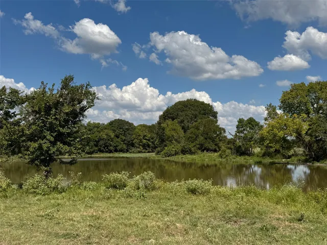 a view of a lake with houses in the background