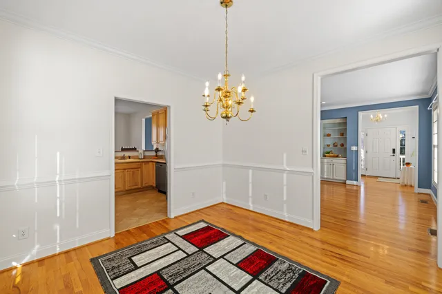 a hallway with a book shelf and wooden floor