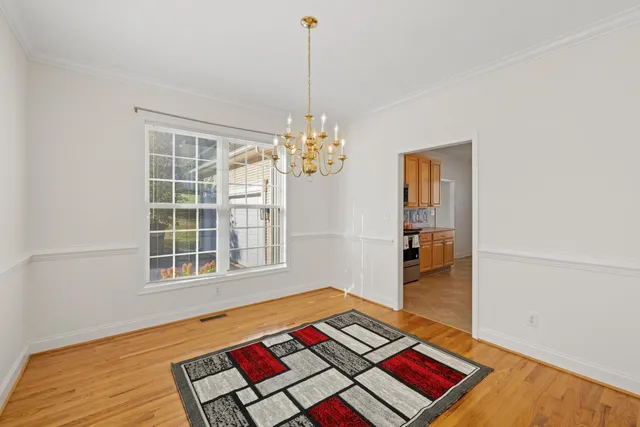 a living room with a bed and a table with bookshelf