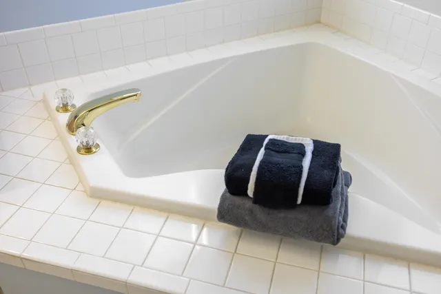 a bathroom with a sink mirror vanity and toilet