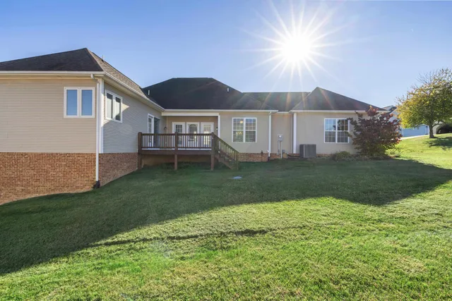 an aerial view of a house with a garden and lake view