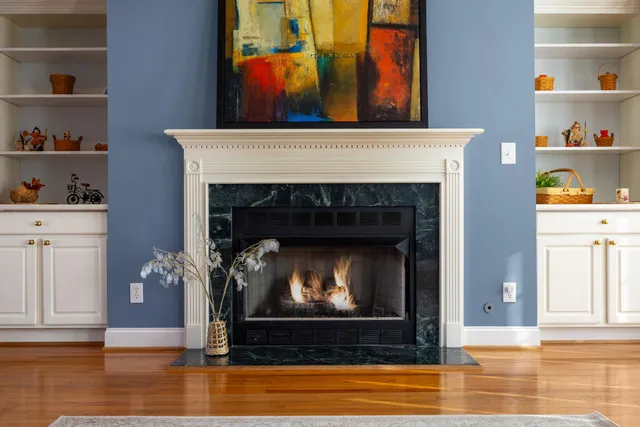 a living room with a fireplace and a wooden floor