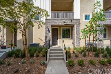 7366 Solstice Place Rancho Cucamonga, CA 91739 - Photo 25 of 32 a front view of a house with a garden