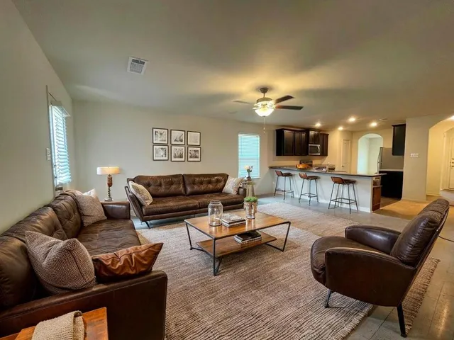 a living room with furniture and a wooden floor