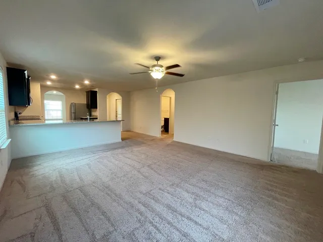 a view of a kitchen with a sink and a chandelier fan