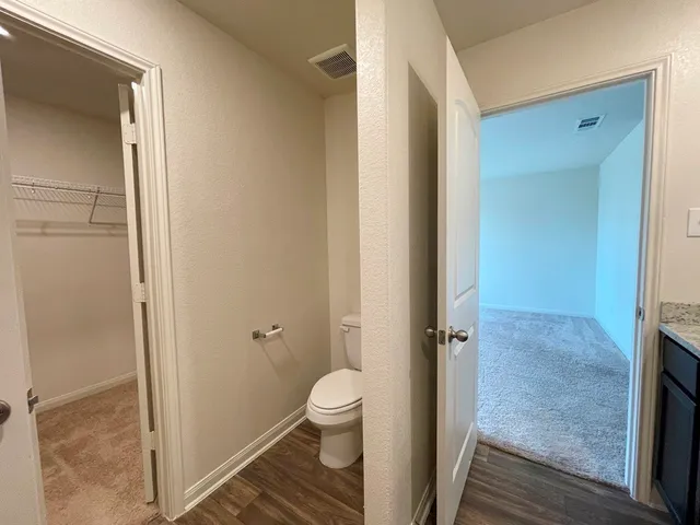 a bathroom with a granite countertop toilet