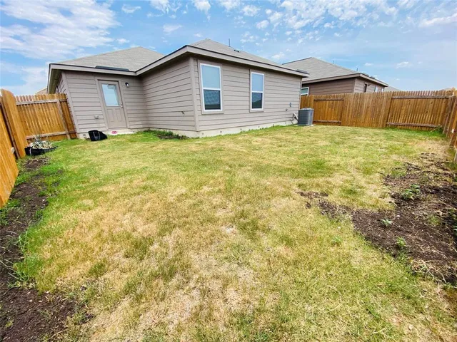 a big room with yard and a large tree center in it