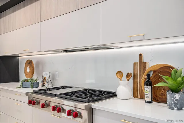 a kitchen with a stove and a wooden floor