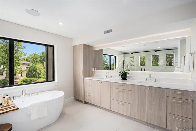 a bathroom with a large tub sink and window
