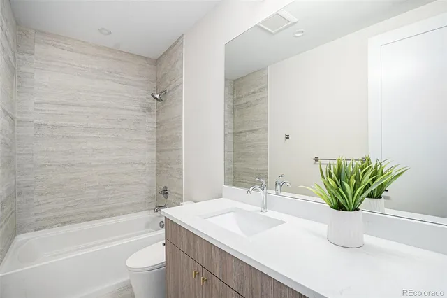 a front view of house with yard and trees in the background