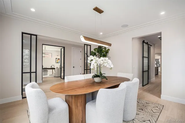 a dining room with furniture and wooden floor