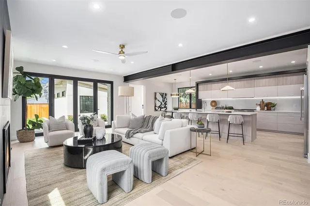 a living room with furniture potted plant and a large window