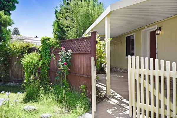 a view of a house with porch and garden