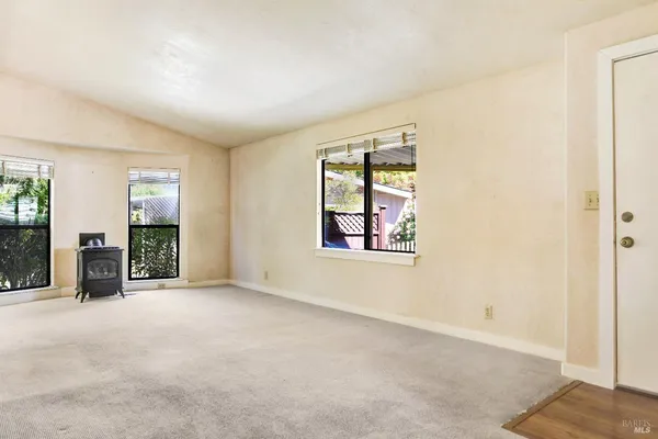 an empty room with windows and closet