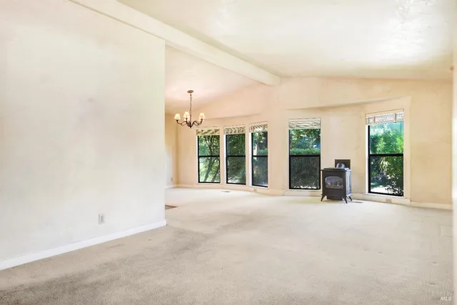 an empty room with windows and large windows