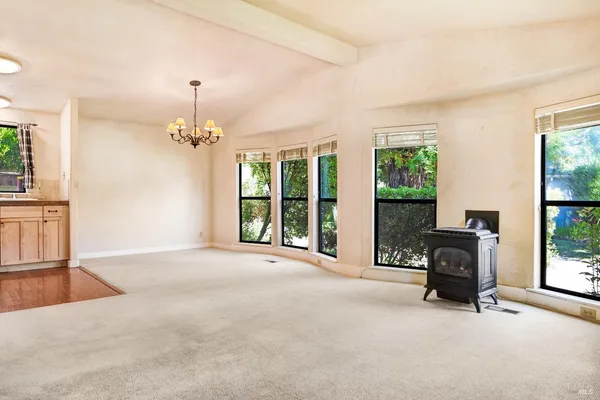 a view of an empty room with furniture and a fireplace