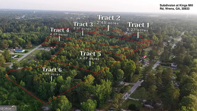 a view of a city with lush green forest