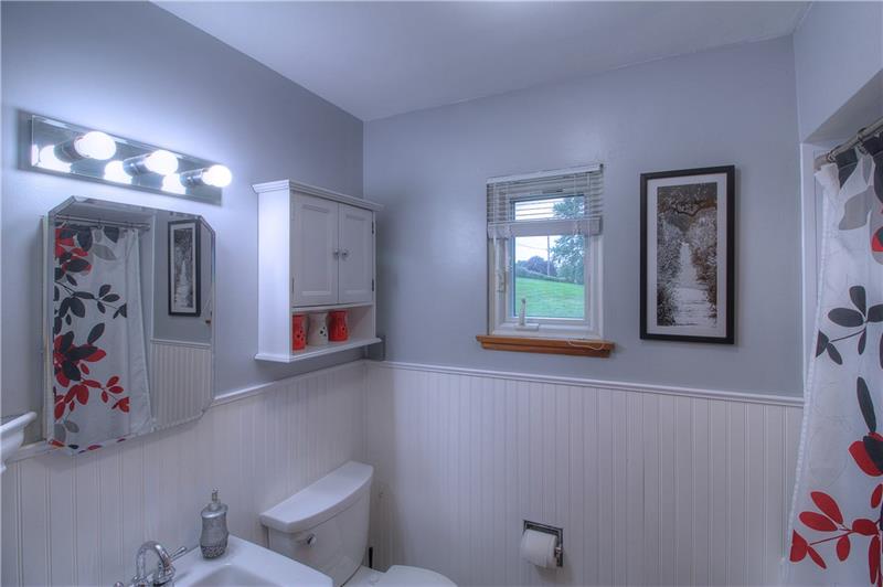 2014 Clayton Road Beaver Falls, PA 15010 - Photo 14 of 24 Fully remodeled bathroom features wainscoting, tub/shower, vanity, lighting, and more!