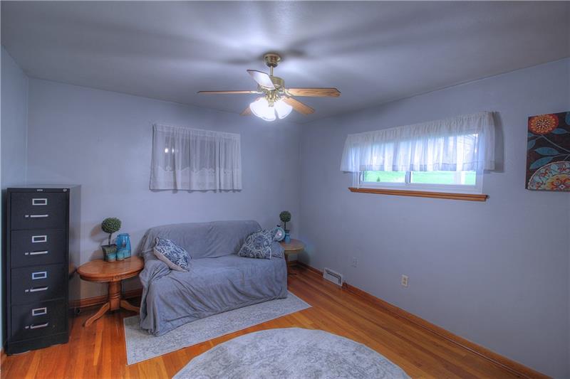 2014 Clayton Road Beaver Falls, PA 15010 - Photo 16 of 24 Bedroom 2 boasts the same gleaming hardwood floors, ceiling fan and good natural light.