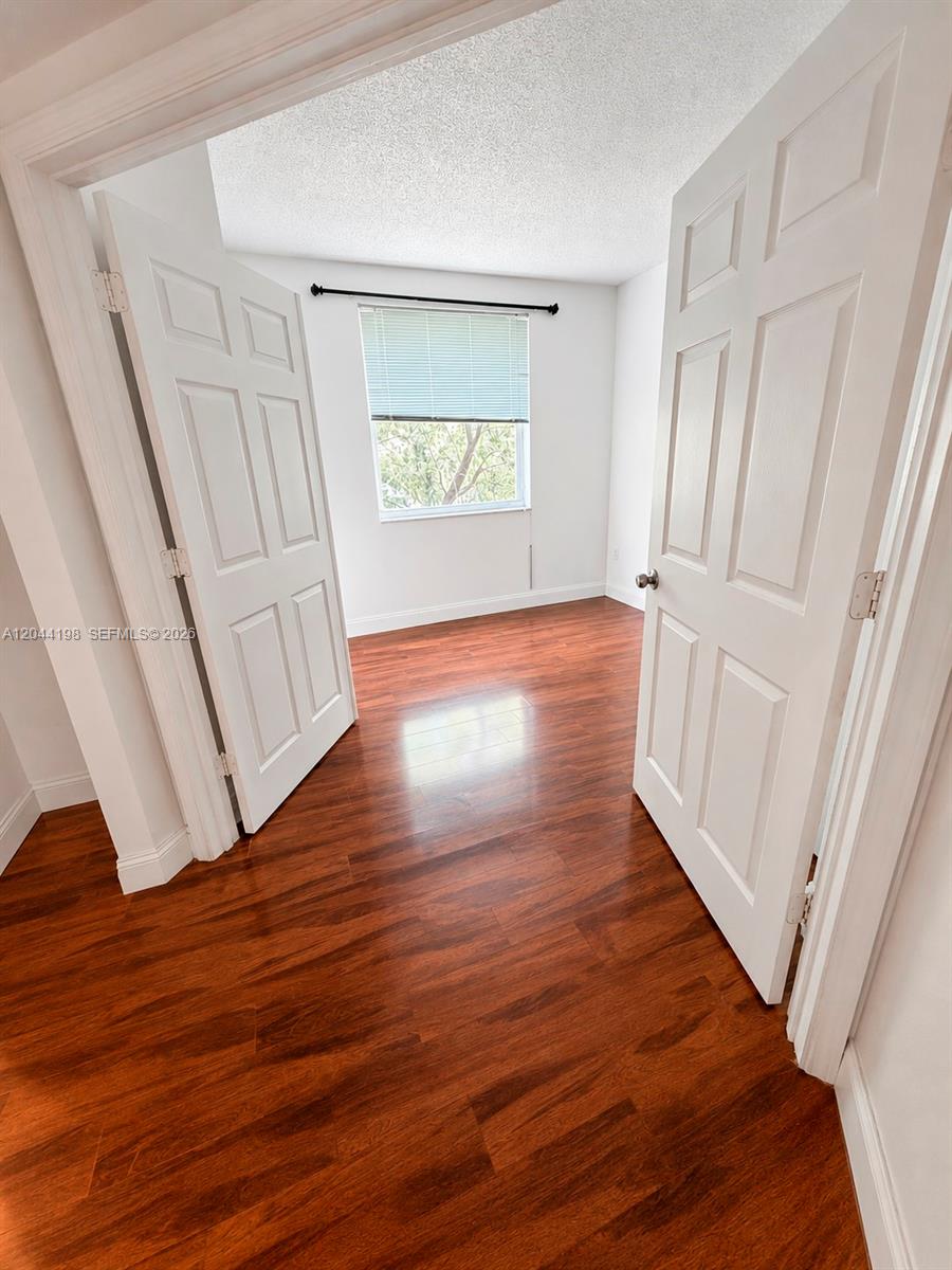 17145 North Bay Road, Unit 4307 Sunny Isles Beach, FL 33160 - Photo 16 of 35 wooden floor in an empty room with a window