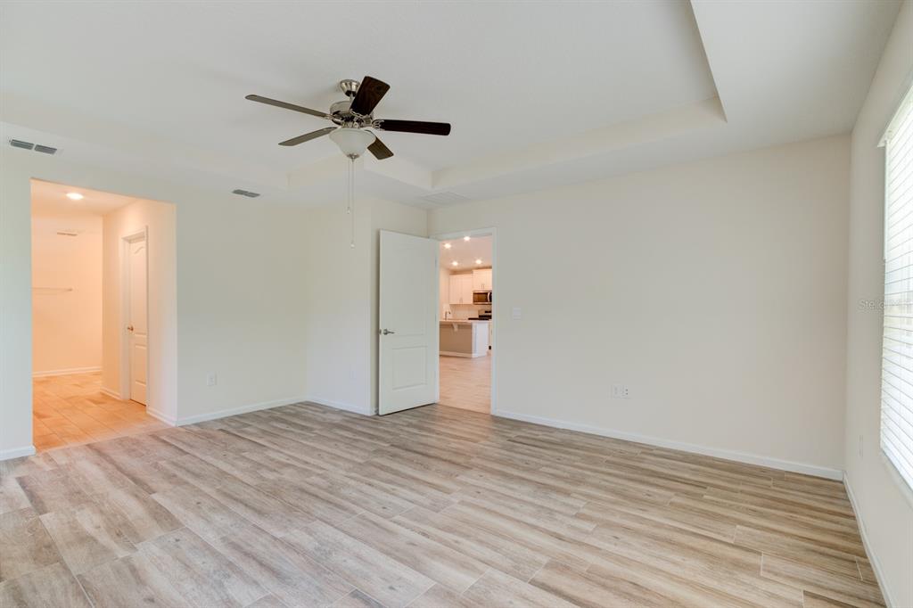 9 Ace Court Bunnell, FL 32110 - Photo 14 of 51 a view of empty room with wooden floor and ceiling fan