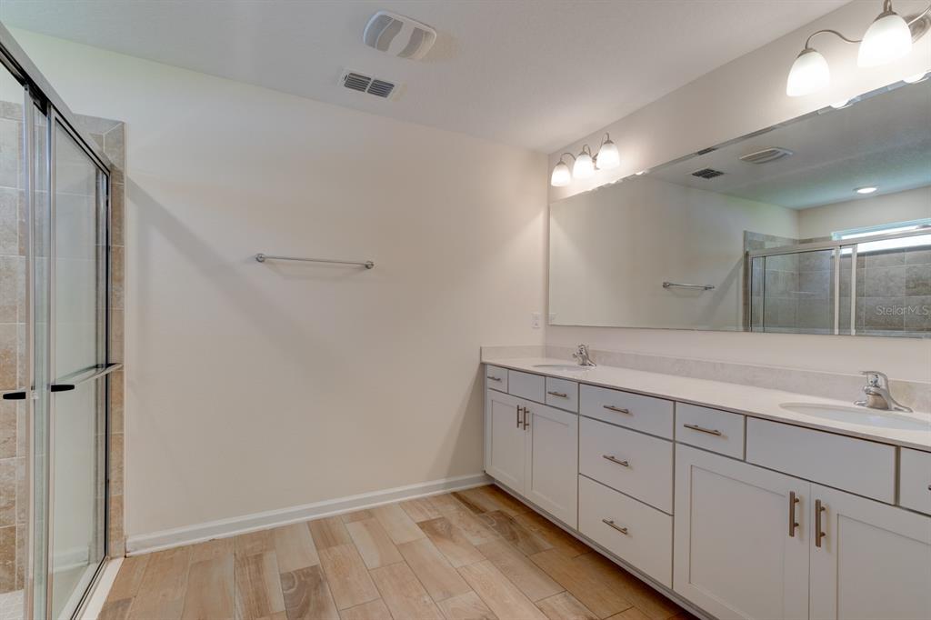 9 Ace Court Bunnell, FL 32110 - Photo 16 of 51 a bathroom with a double vanity sink and mirror