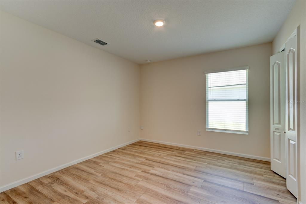 9 Ace Court Bunnell, FL 32110 - Photo 18 of 51 an empty room with wooden floor and windows