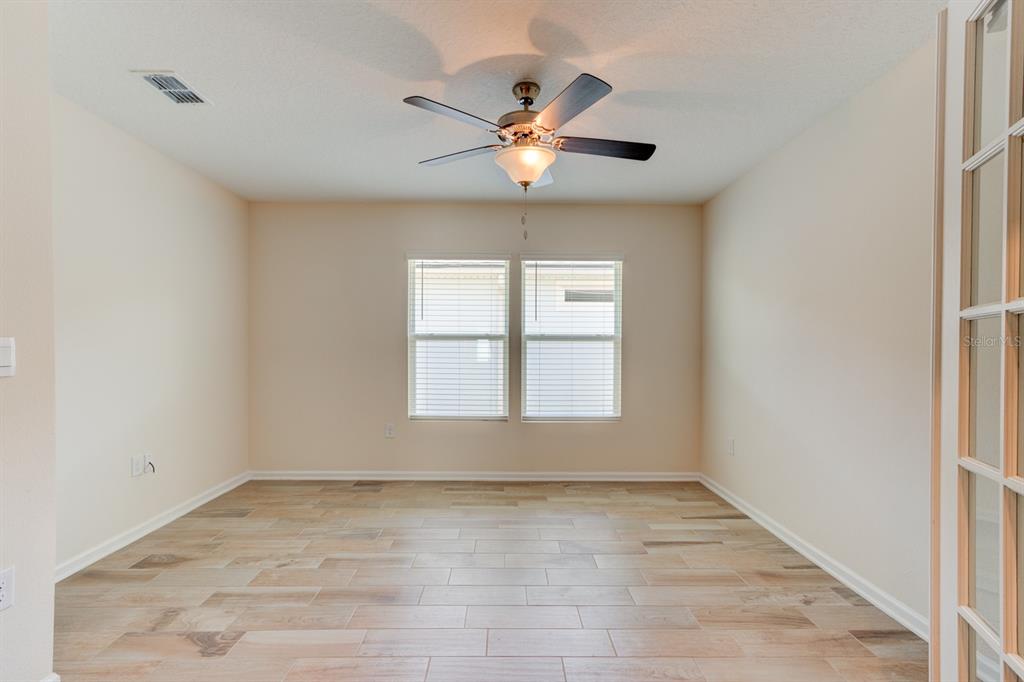 9 Ace Court Bunnell, FL 32110 - Photo 20 of 51 an empty room with a window and a ceiling fan