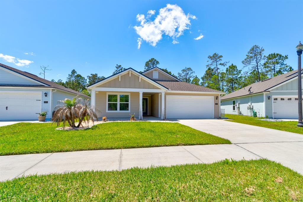9 Ace Court Bunnell, FL 32110 - Photo 2 of 51 a front view of a house with a yard and garage