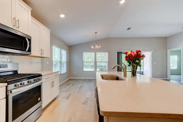 a view of a kitchen with microwave and stove