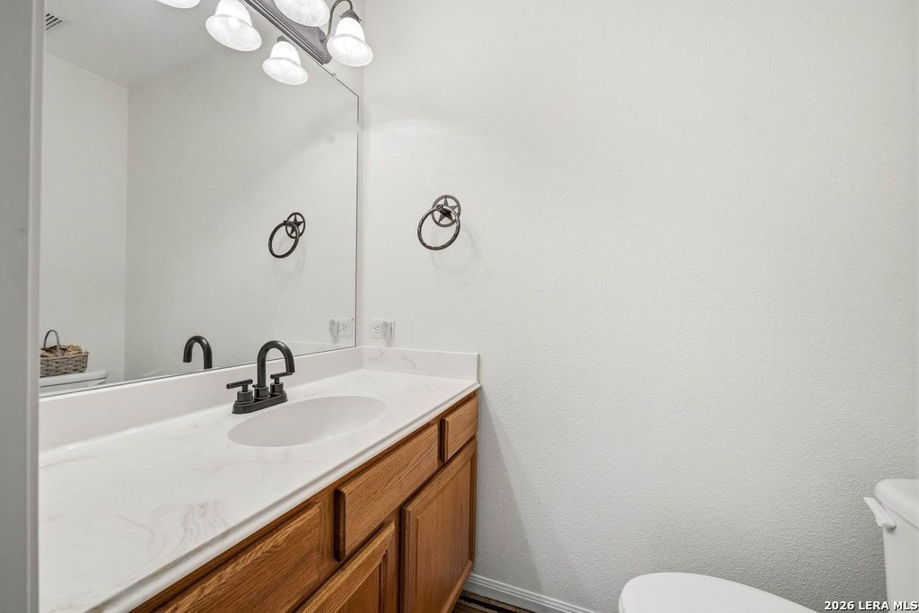 318 River Ridge Boerne, TX 78006 - Photo 28 of 46 a bathroom with a sink a toilet and a mirror