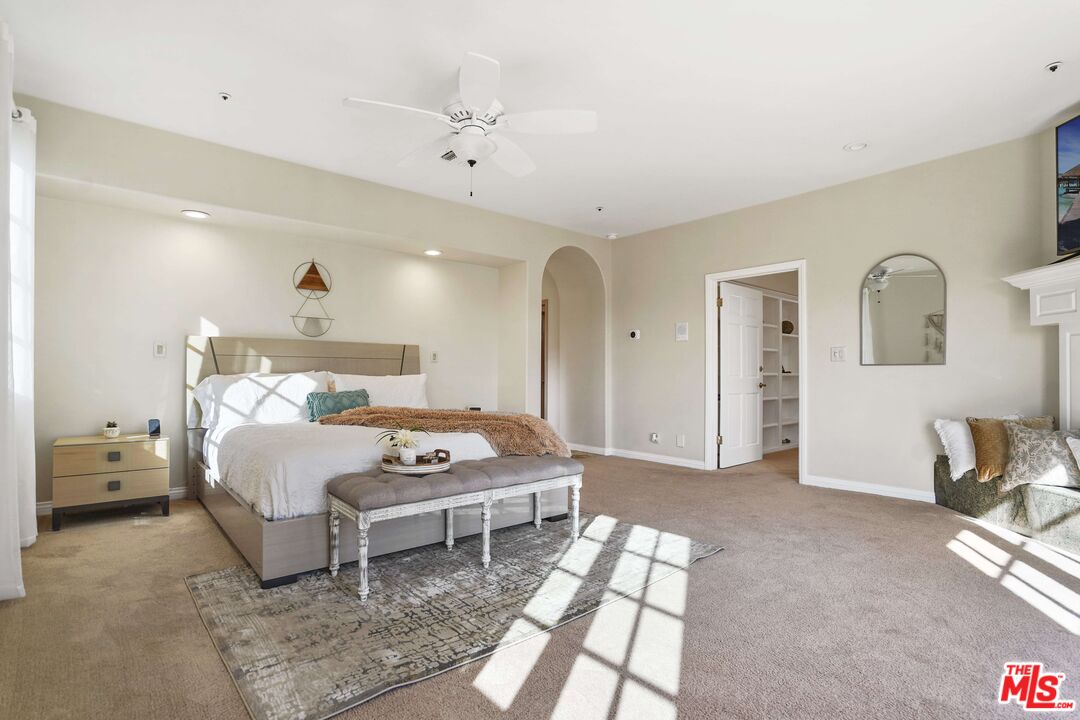 19 Ranchero Road Bell Canyon, CA 91307 - Photo 18 of 42 a bedroom with a bed and a chandelier