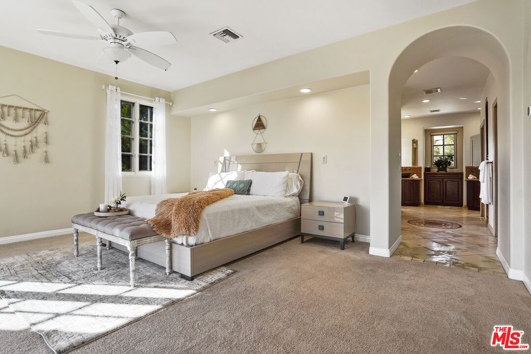 19 Ranchero Road Bell Canyon, CA 91307 - Photo 19 of 42 a bedroom with a bed and a chandelier