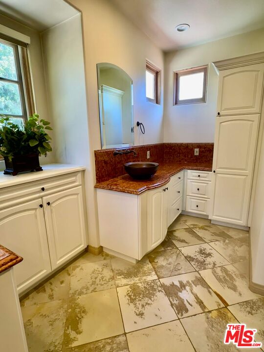 19 Ranchero Road Bell Canyon, CA 91307 - Photo 23 of 42 a kitchen with a stove and a white cabinet