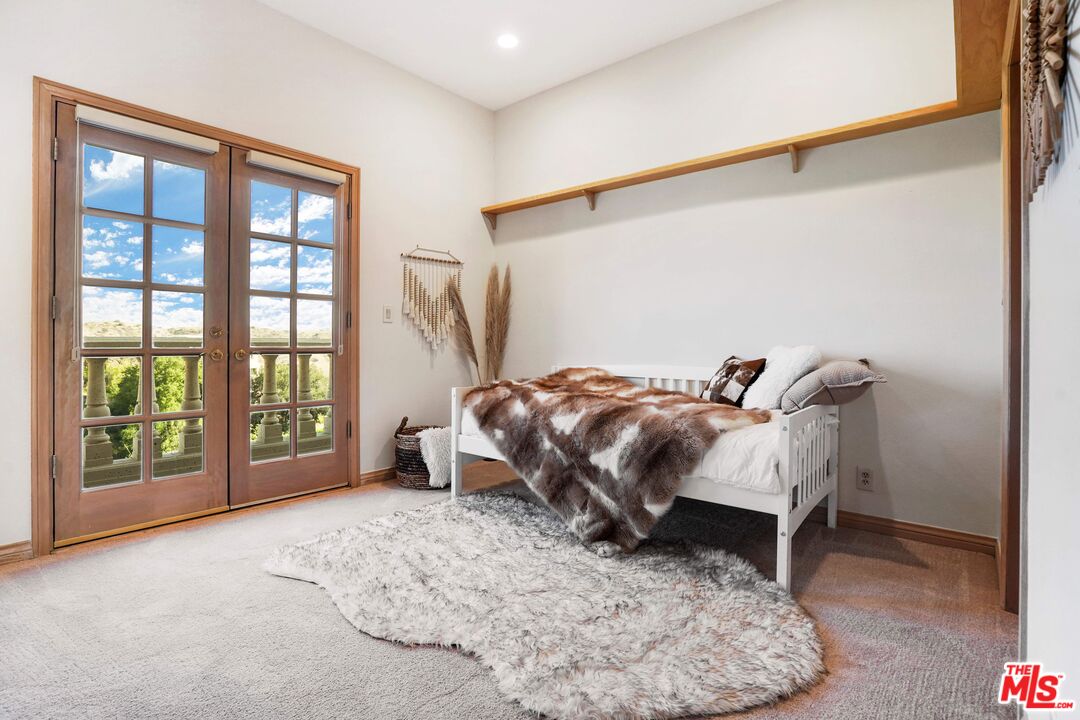 19 Ranchero Road Bell Canyon, CA 91307 - Photo 27 of 42 a bedroom with a bed and a large window