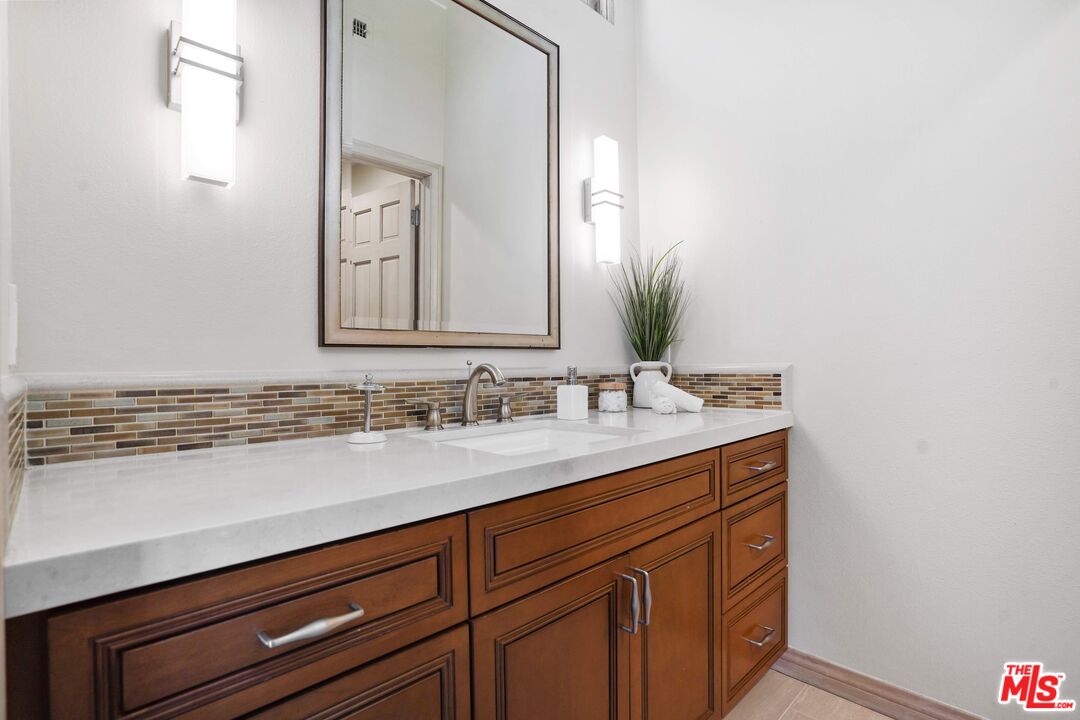 19 Ranchero Road Bell Canyon, CA 91307 - Photo 32 of 42 a bathroom with a sink and a mirror