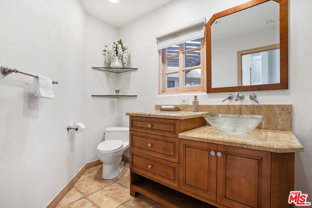 19 Ranchero Road Bell Canyon, CA 91307 - Photo 33 of 42 a bathroom with a granite countertop sink vanity mirror and toilet