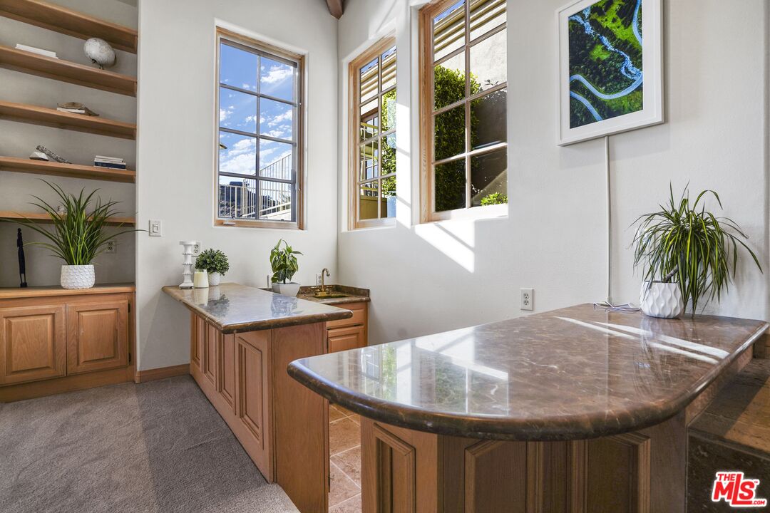 19 Ranchero Road Bell Canyon, CA 91307 - Photo 8 of 42 a kitchen with a granite countertop sink a stove and a window