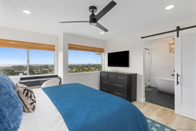 a bedroom with a bed and a flat screen tv