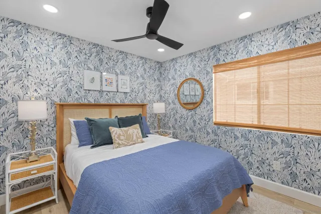 a bedroom with a large bed and a window