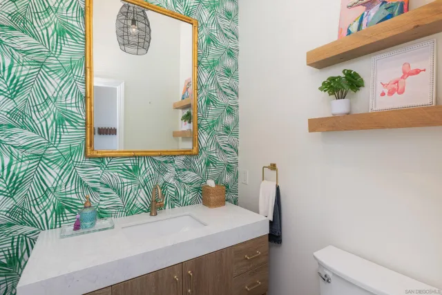a bathroom with a sink a toilet and mirror