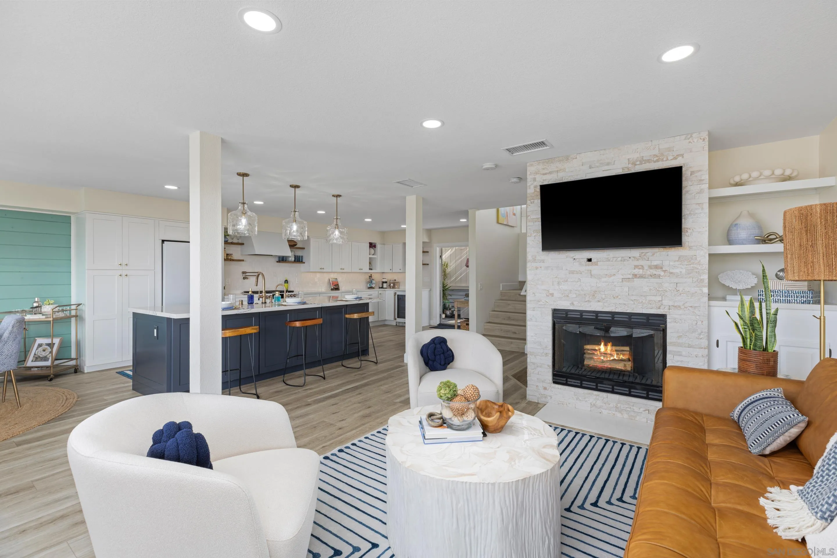 579 Hygeia Avenue, Unit A Encinitas, CA 92024 - Photo 19 of 25 a living room with furniture a fireplace and a flat screen tv
