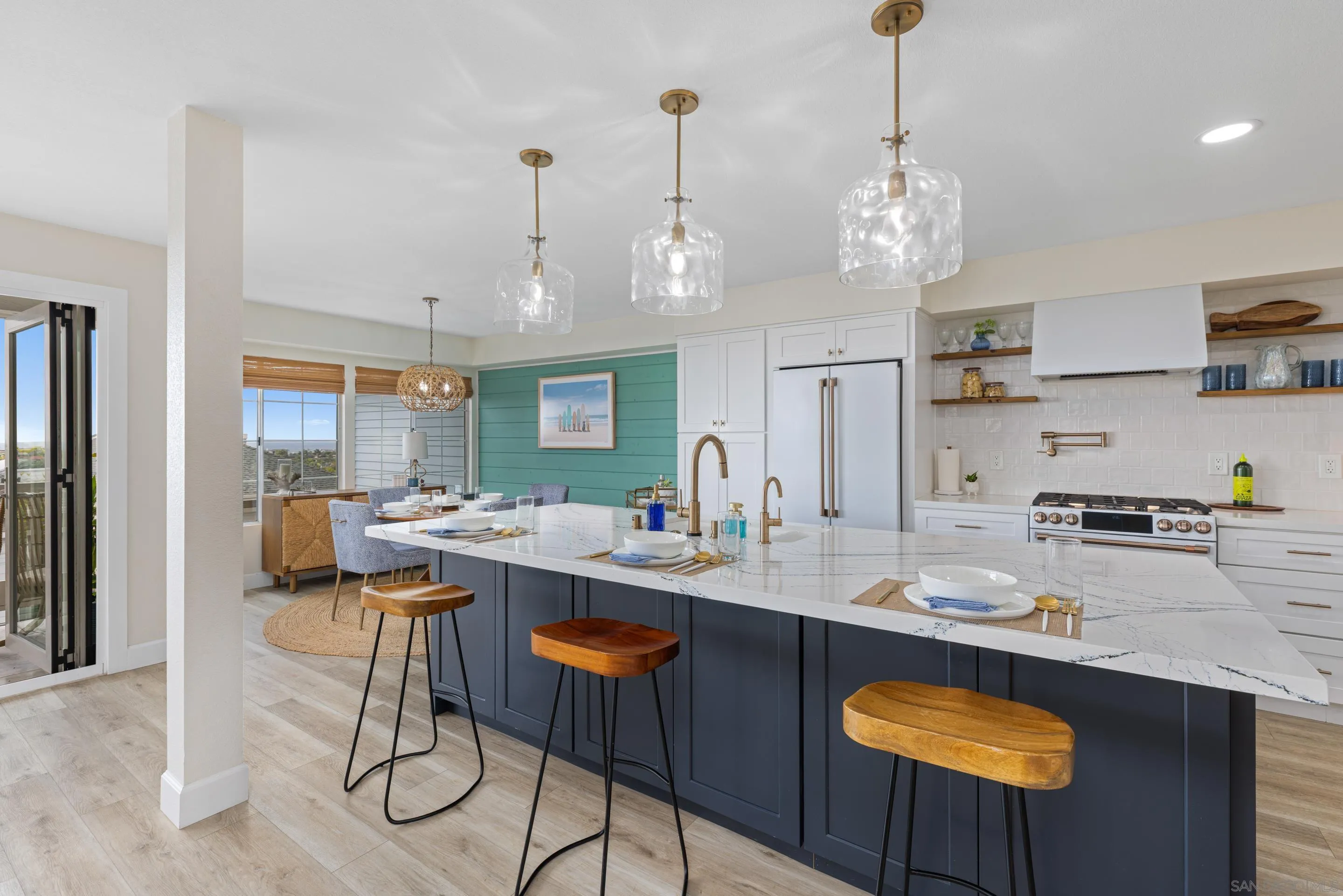 579 Hygeia Avenue, Unit A Encinitas, CA 92024 - Photo 20 of 25 a kitchen with stainless steel appliances granite countertop a sink a stove a kitchen island with chairs and cabinets