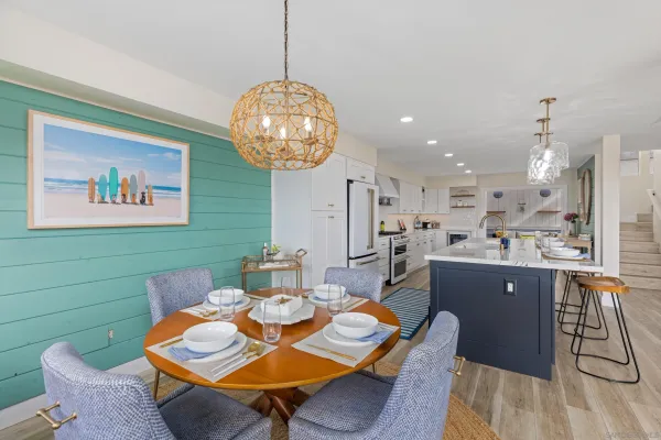 a view of a dining room with furniture a chandelier and wooden floor