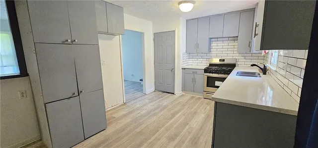 a kitchen with a refrigerator stove and sink