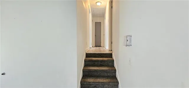 a view of staircase with white walls