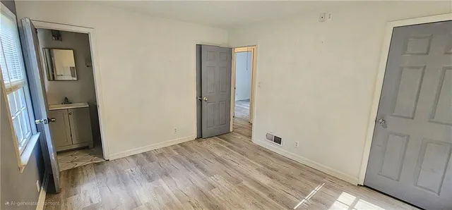 a view of a hallway with wooden floor and a refrigerator
