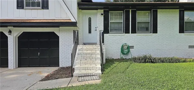 a front view of a house with garden
